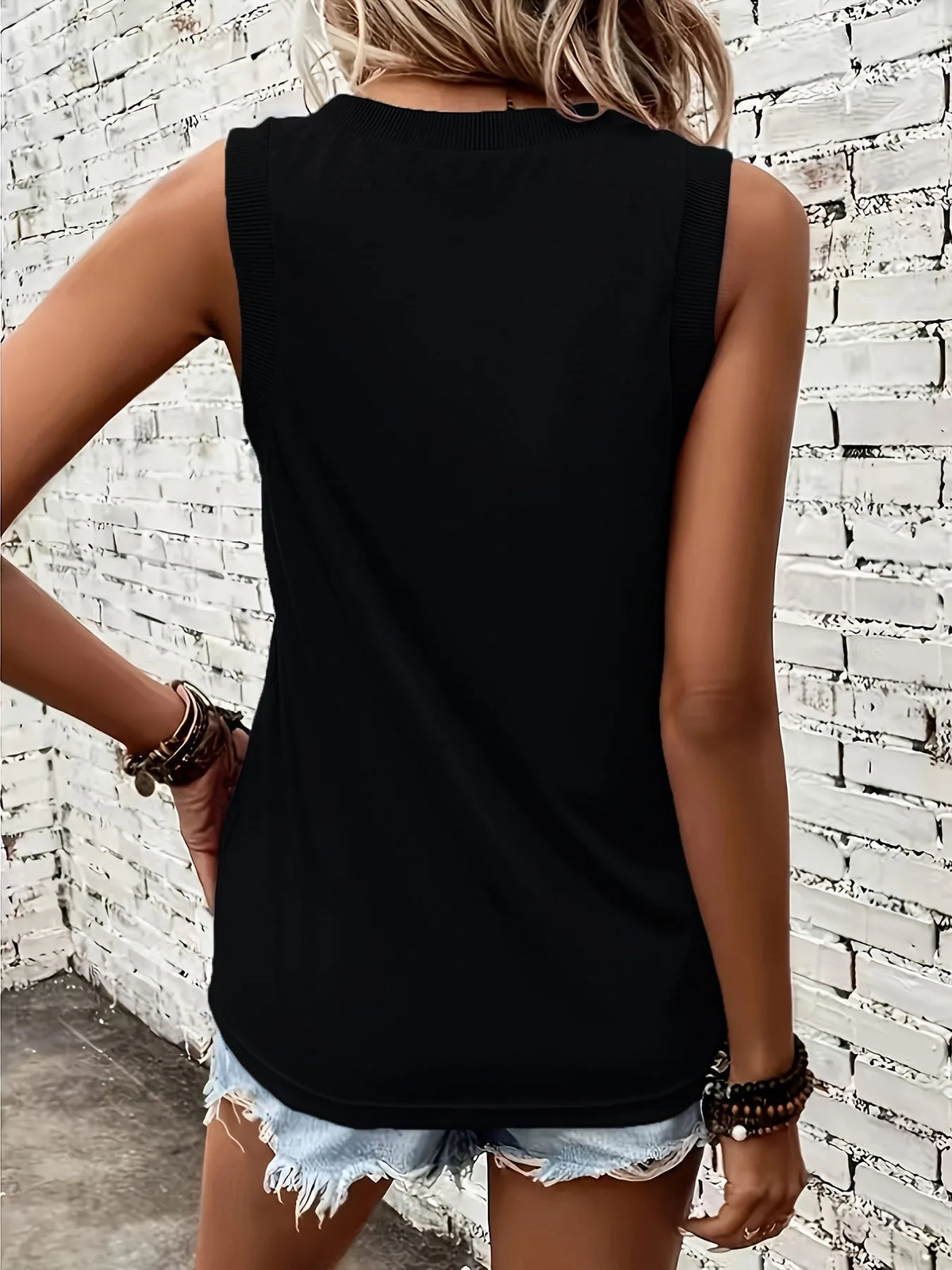 Back view of the black singlet showing the relaxed fit and ribbed shoulder trim