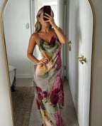 Mirror selfie showing the cowl neckline and beaded straps of the floral maxi dress styled with gold jewellery