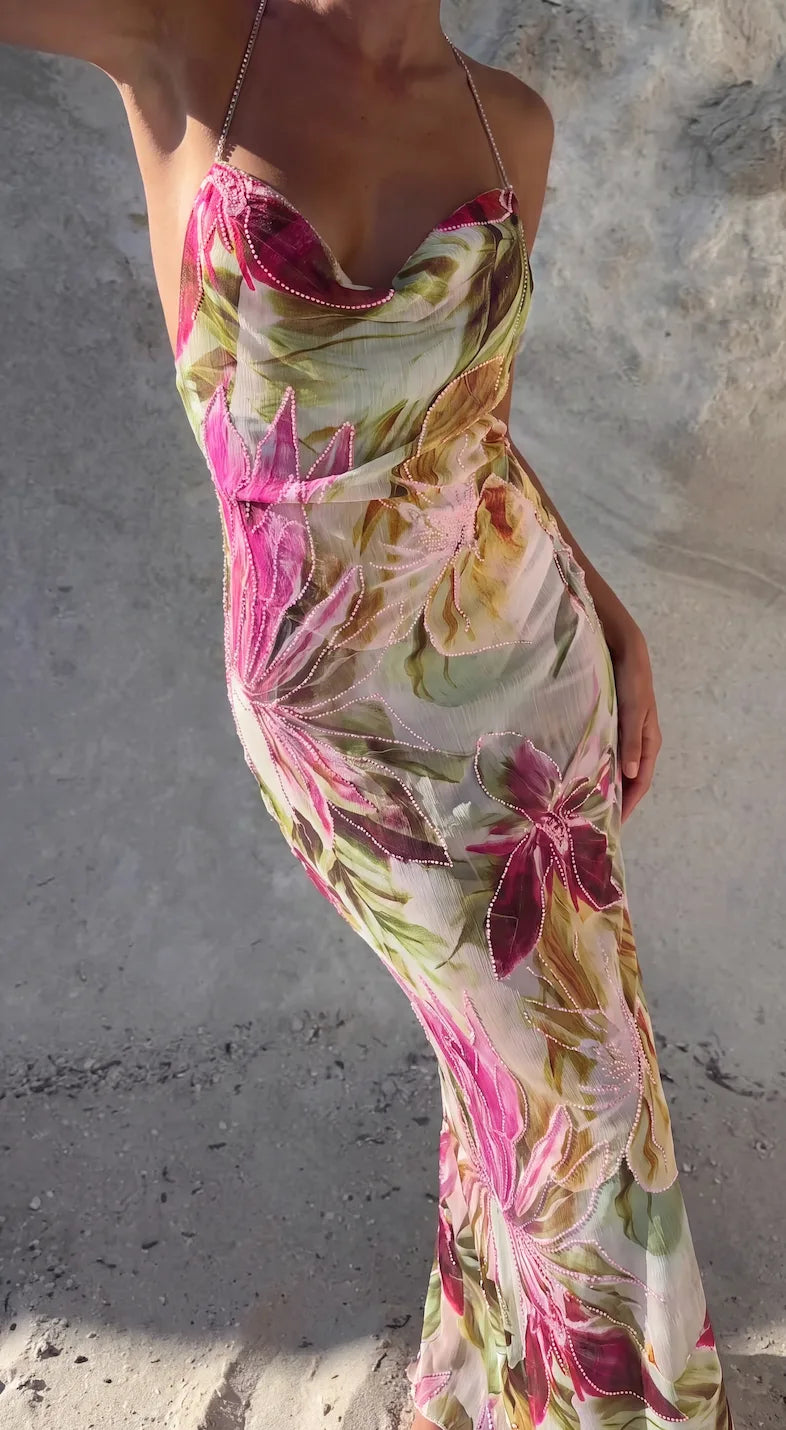 Close-up side angle of the floral beaded maxi dress showing the fitted waist and draped fabric in natural light