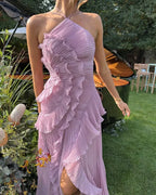 Close-up of ruffle and pleat texture on the bodice of the yellow halter maxi dress