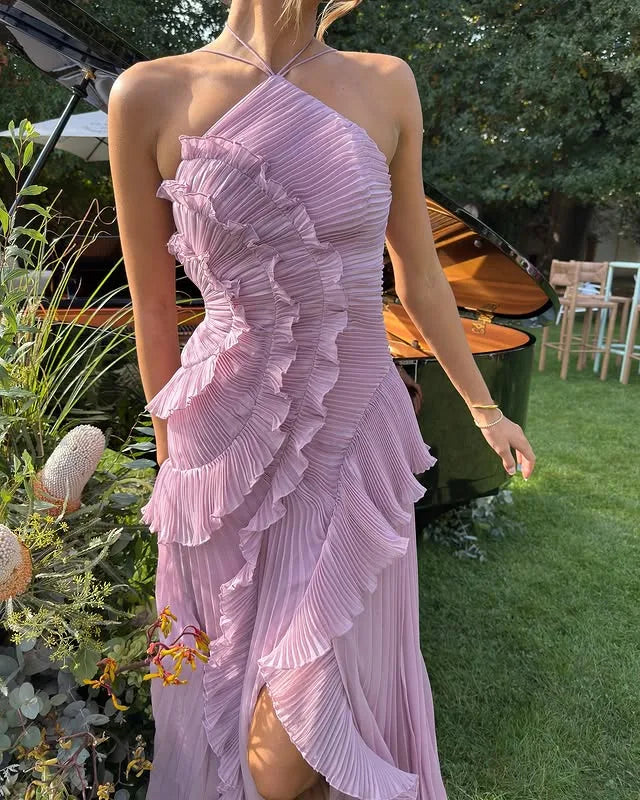 Close-up of ruffle and pleat texture on the bodice of the yellow halter maxi dress