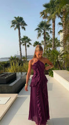 Close-up of the side slit and vertical pleating on the lower skirt of the dress