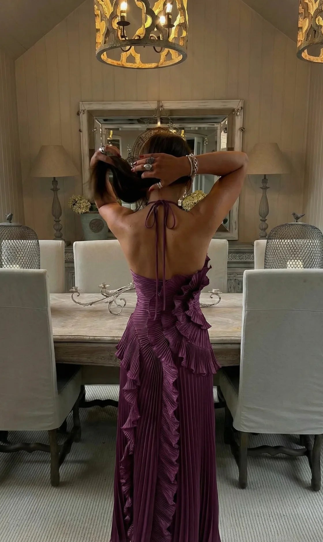 Side angle of the pleated ruffle cascading from bodice to hem on the maxi dress