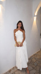Model seated showing the drape of the pleated skirt across the lap