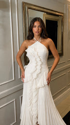 Detail of the dress paired with layered gold bracelets and a structured handbag
