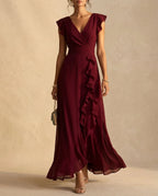 Wine coloured V-neck maxi dress with vertical ruffle detail flowing down the front of the skirt