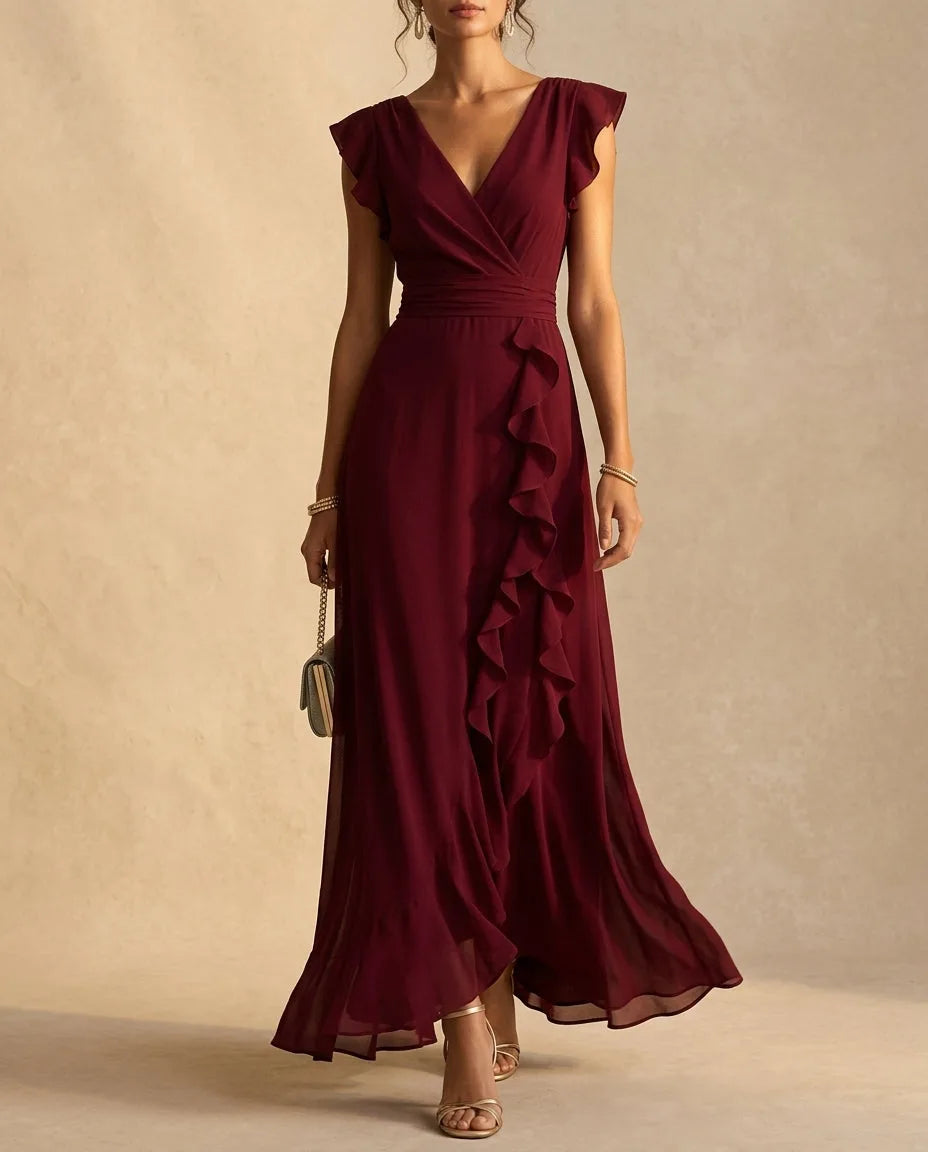 Wine coloured V-neck maxi dress with vertical ruffle detail flowing down the front of the skirt