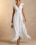 White ruffle wrap-style maxi dress with tie waist and cascading skirt ruffle, floor length hem