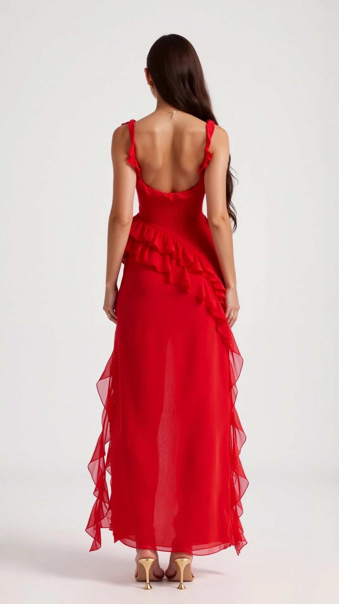 Side angle of black ruffled maxi dress showing the diagonal ruffle trim and high leg slit in motion