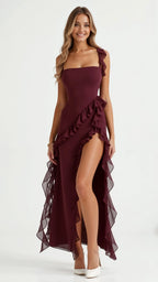 Detail shot of black ruffled maxi dress ruffle trim along the hemline and sheer chiffon-like fabric