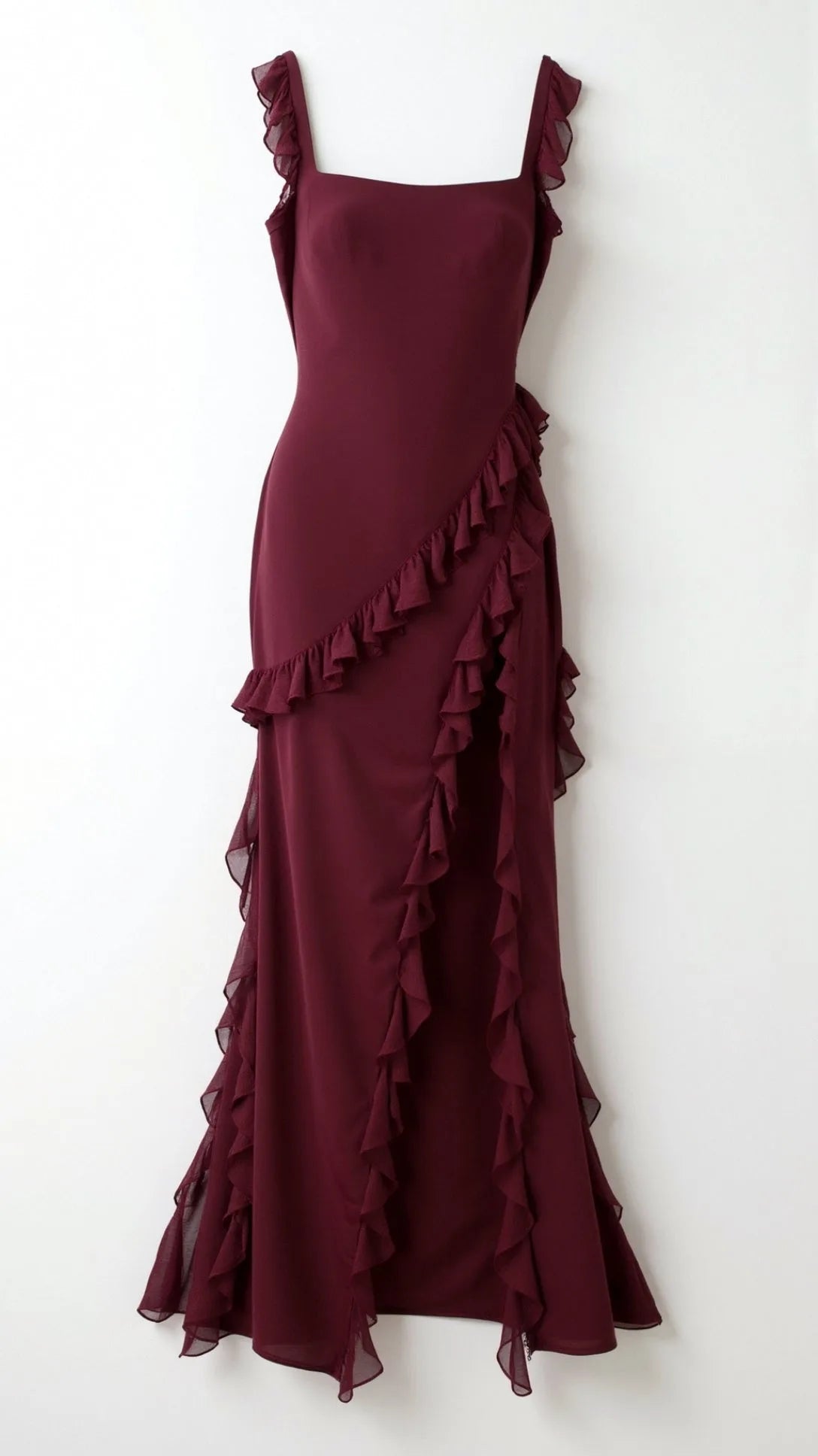 Close-up of dark brown ruffled maxi dress neckline and ruffle strap detail against tanned skin