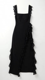 Side angle of pale blue ruffled maxi dress showing the cascading ruffle trim along the skirt and slit