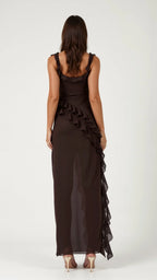 Back view of dark brown ruffled maxi dress showing open low back and ruffle detail trailing down the skirt