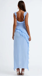 Back view of pale blue ruffled maxi dress showing the low back cut and cascading ruffle trim