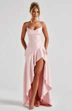 Full front view of the same style in vivid red satin with thigh-high split and ruffled asymmetric hem