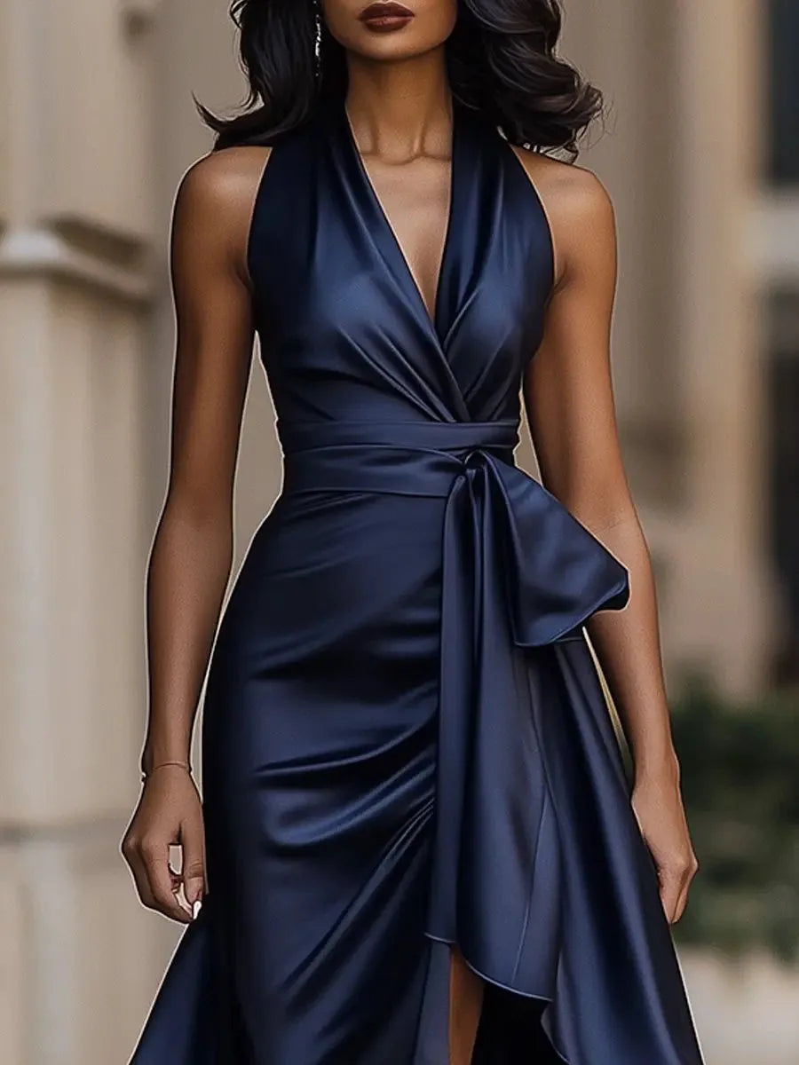 Side profile of the satin maxi dress showing the draped skirt and asymmetric ruffled hem falling to the ankle