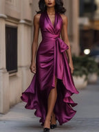 Dark pink satin halterneck maxi dress with cinched tie waist and flowing ruffled skirt panel