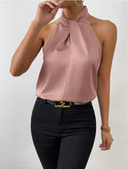 Dusty pink satin halter top with knot neck, close-up showing the soft sheen and centre seam detail