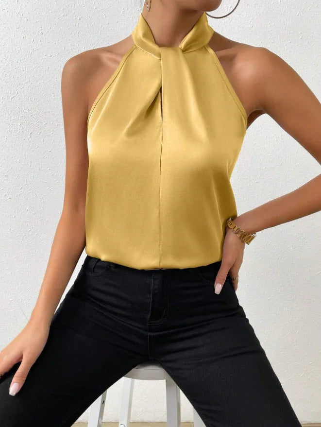 Mustard yellow satin halter top with knotted neckline, close-up showing fabric sheen and relaxed bodice