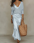 Pale blue satin slip maxi dress worn with a matching light blue V-neck knit jumper