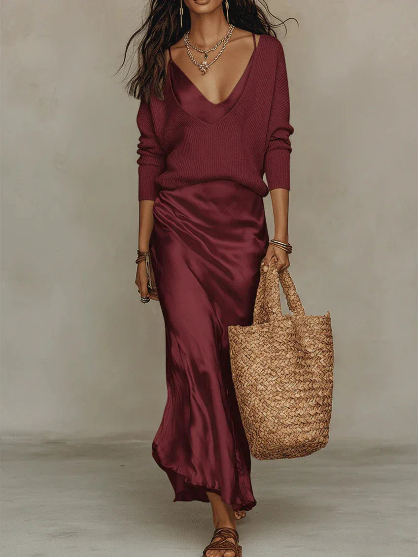 Side view of the satin slip dress showing the fluid drape and ankle-grazing hemline with sandals