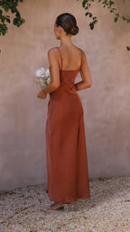 Back view of the rust brown satin maxi dress showing thin adjustable straps and smooth draped skirt