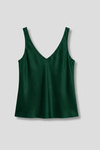 Flat lay of a dark green satin singlet with V-neck front and back, wide straps, on a grey background