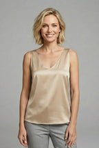 Side angle of a woman wearing a black satin V-neck singlet, showing the fit through the torso