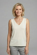 Close-up of the shoulder strap and V-neck seam on an olive green satin singlet