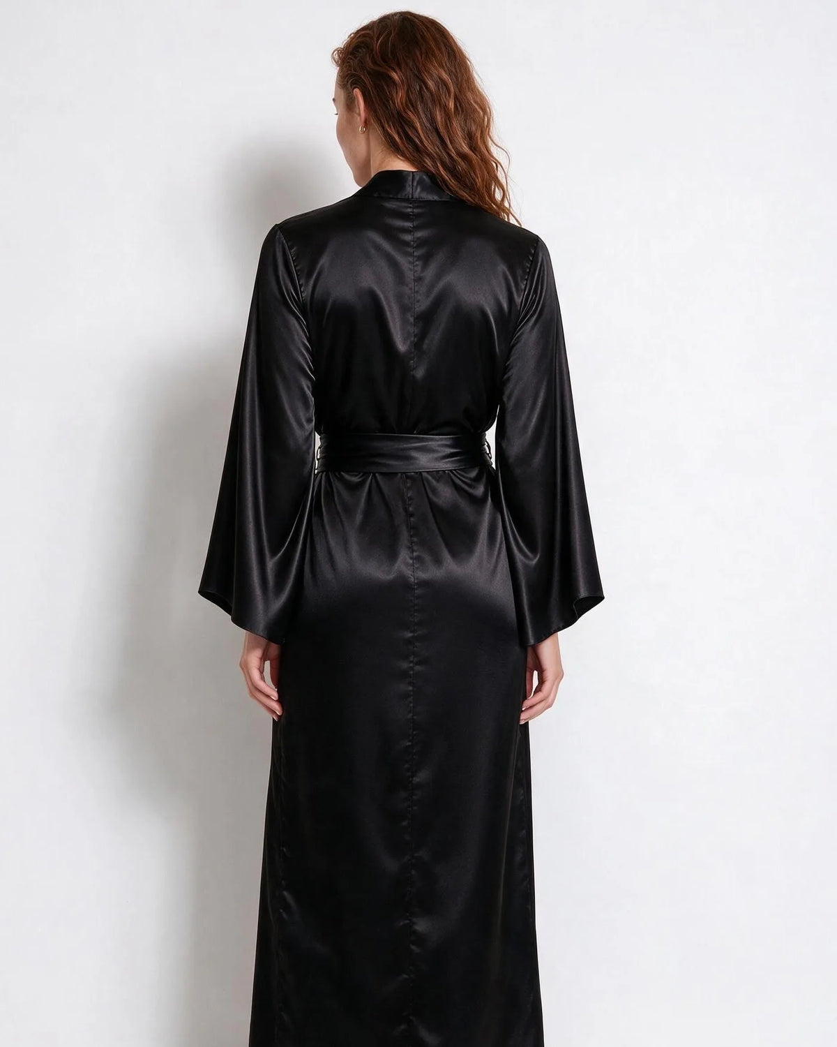 Detail of the flared sleeve cuff on the red satin robe, showing the wide bell shape
