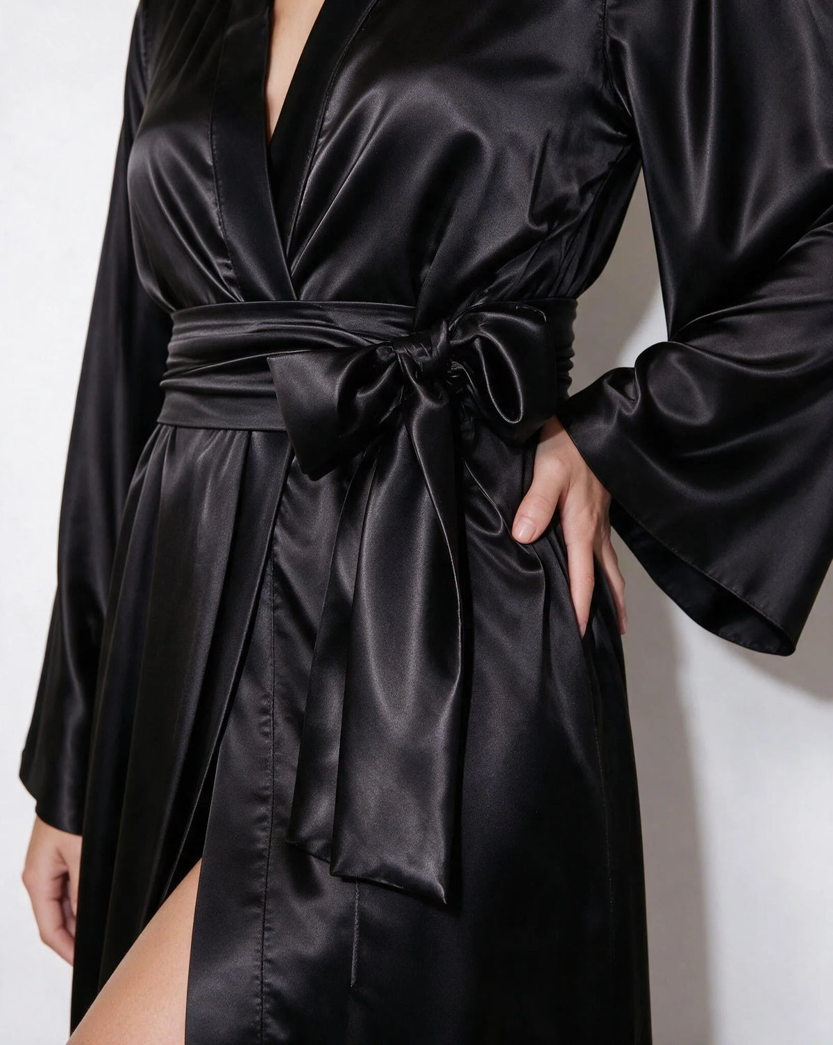 Close-up of the wrap neckline on the red satin robe, showing the V-shaped front opening