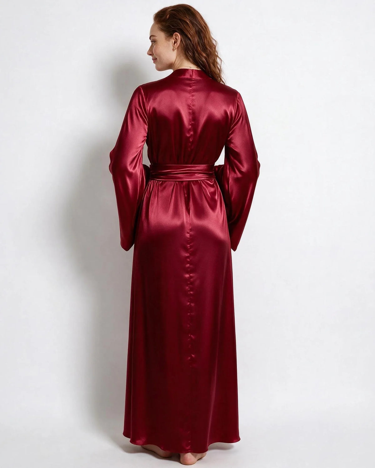Woman in red satin robe with arms relaxed, showing the drape of the wide sleeves from the front