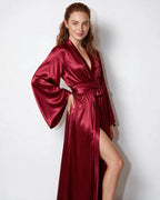 Close-up of the waist tie and fabric folds on the red satin robe