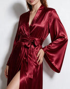 Full front view of woman in forest green satin robe with sash tied and leg slit visible