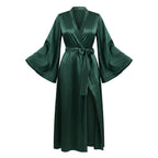 Forest green satin robe laid flat, showing the wrap front, sash belt and bell sleeves