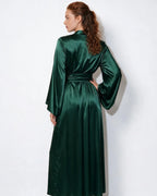 Close-up of the sash belt tied at the waist on the red satin robe, showing fabric sheen