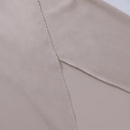 Overhead flat lay of the beige satin maxi dress laid flat, showing the fitted waist and wrap skirt