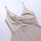 Side angle of the dress on a model showing how the fabric skims the waist before falling into the skirt