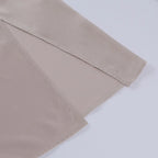 Detail shot of the thigh-high side slit on the satin maxi dress, showing the layered fabric opening