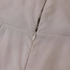 Close-up of the back strap and zipper closure on the satin maxi dress