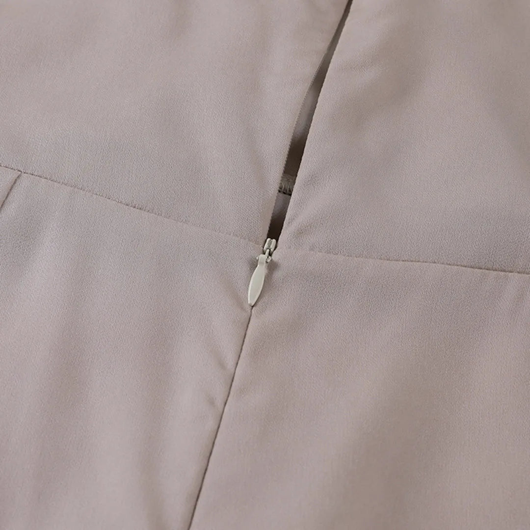 Close-up of the back strap and zipper closure on the satin maxi dress
