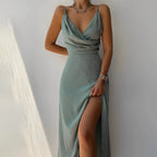 Side view of a sage green satin maxi dress with cowl-draped bodice and thin adjustable straps