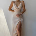 Beige satin maxi dress shown on a model, highlighting the wrap front bodice and flowing skirt with side slit