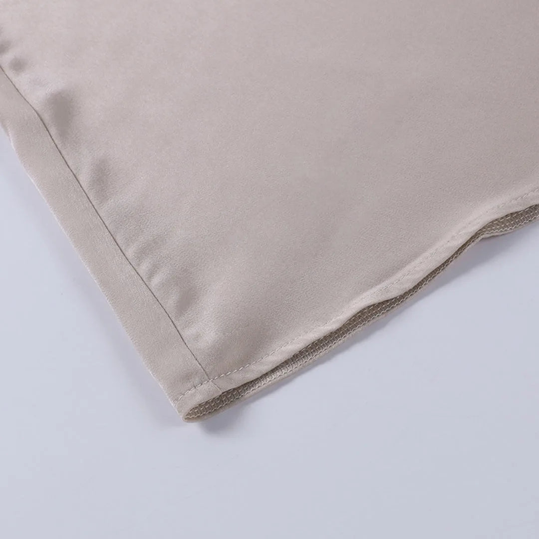 Flat lay of the dress bodice showing both adjustable straps, V-neckline and centre back zipper