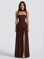 Front view of a sculpted brown maxi dress with scarf-tie neckline, cut-out straps and a high side slit