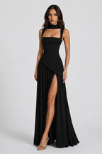 Full-length front view of the burgundy maxi gown paired with nude strappy heels