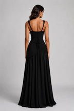 Front view of the burgundy dress skirt detail showing the asymmetric draped gather and high slit