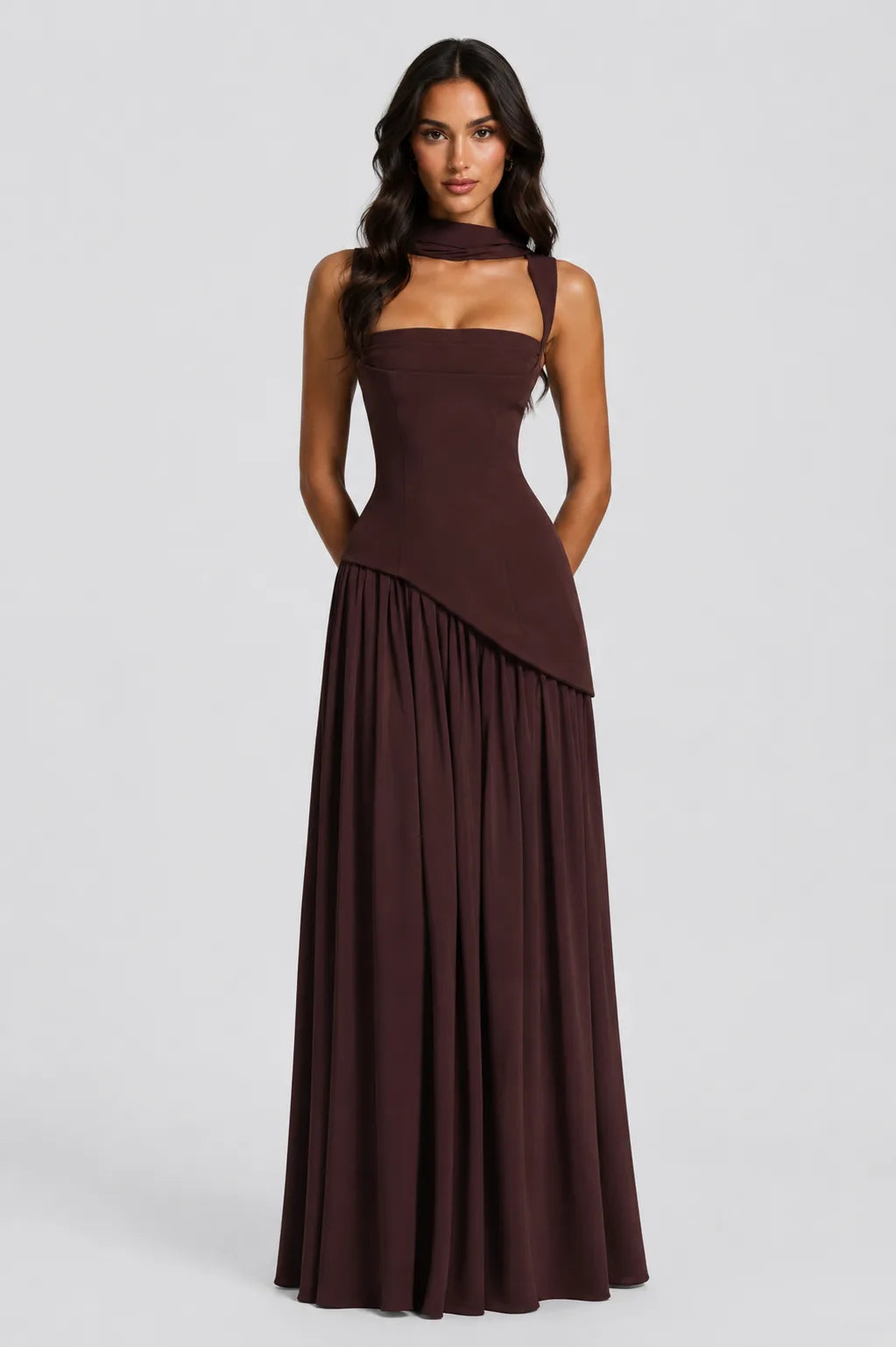 Close front view highlighting the sculpted bustier bodice and asymmetric gathered skirt in brown