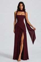 Front view of a burgundy satin-feel maxi dress with sculpted bodice, scarf neckline and leg slit