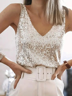 Close-up of a silver sequin V-neck singlet top with wide straps worn with a white belted skirt